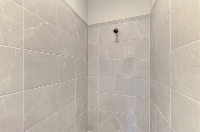 interior details with a tile shower