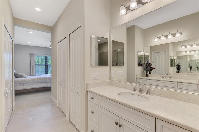 bathroom with vanity, ceiling fan, and tile patterned flooring