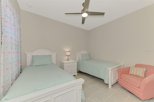 bedroom with ceiling fan and light tile patterned floors