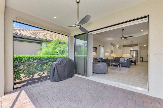 sunroom featuring ceiling fan