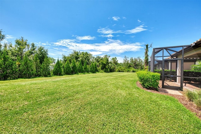 view of yard with glass enclosure