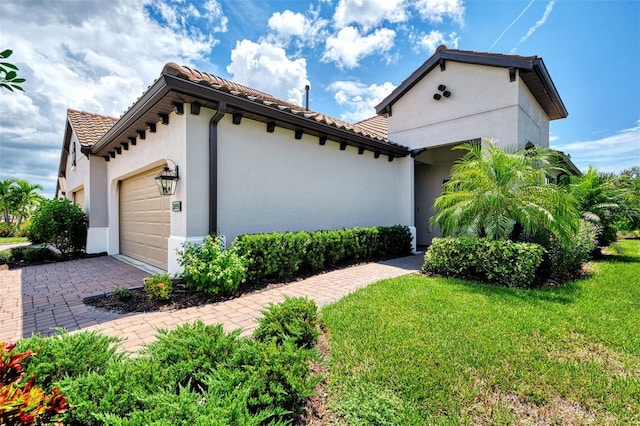 view of property exterior featuring a garage and a yard