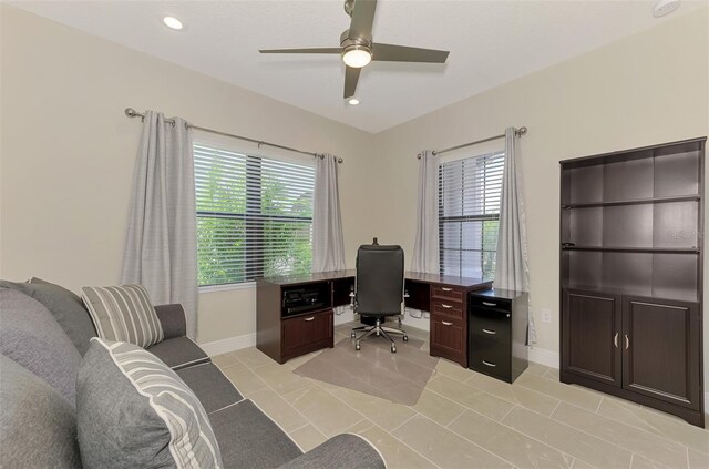 office space featuring light tile patterned floors and ceiling fan