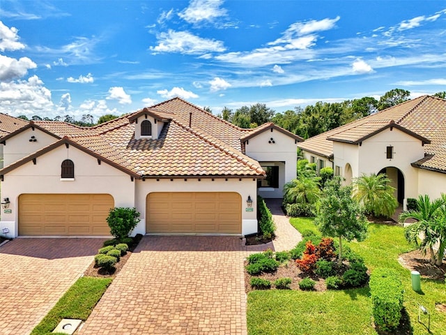 mediterranean / spanish home with a garage