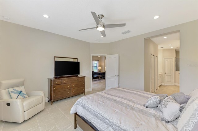 bedroom with ceiling fan and ensuite bath