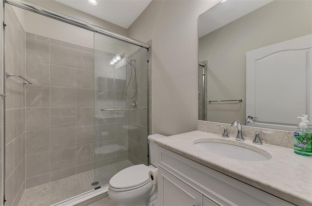 bathroom featuring vanity, toilet, and walk in shower