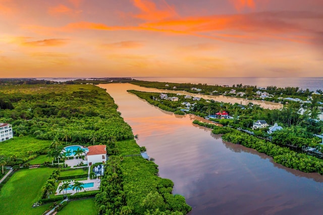 aerial view at dusk with a water view