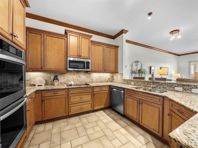 kitchen with light stone counters, appliances with stainless steel finishes, crown molding, and sink