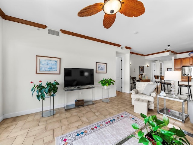 living room with ceiling fan and crown molding