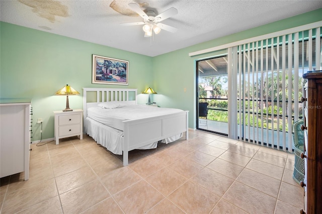 8 Quails Run Blvd Unit 10, Englewood, FL 34223 - tiled bedroom featuring access to outside, a textured ceiling, ceiling fan, and baseboards