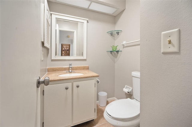 bathroom featuring vanity, toilet, and tile patterned floors