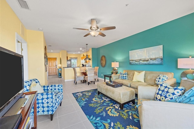 living room with ceiling fan and light tile patterned flooring