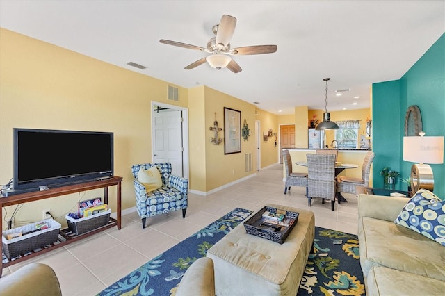 living room featuring ceiling fan and light tile patterned flooring