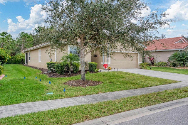 view of front of house with a garage and a front lawn