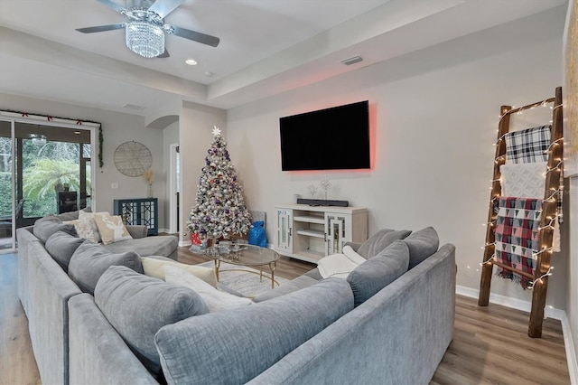 living room with ceiling fan and light hardwood / wood-style floors