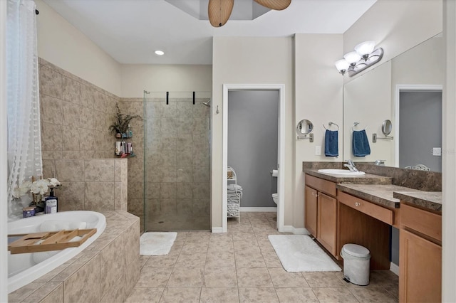 full bathroom with plus walk in shower, tile patterned floors, toilet, ceiling fan, and vanity