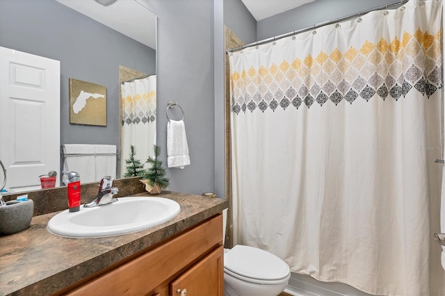 bathroom featuring vanity, toilet, and curtained shower