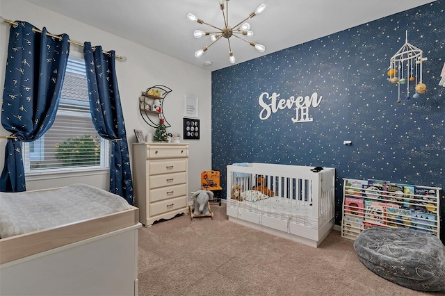 bedroom featuring carpet flooring, a notable chandelier, and a crib