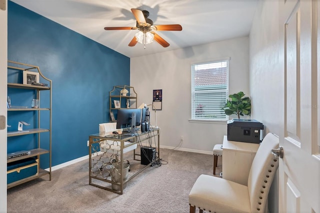 carpeted home office featuring ceiling fan