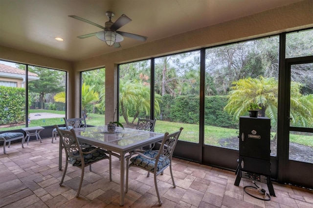 sunroom featuring ceiling fan