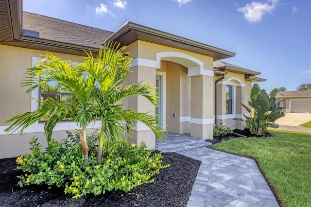 view of front of property with a garage and a front lawn