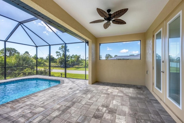 view of swimming pool with a lanai, a patio, and ceiling fan