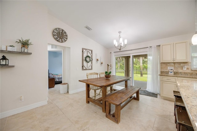 dining space with light tile patterned flooring, lofted ceiling, and a chandelier