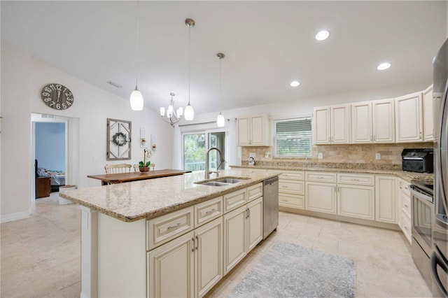 kitchen with sink, decorative light fixtures, decorative backsplash, a center island with sink, and appliances with stainless steel finishes