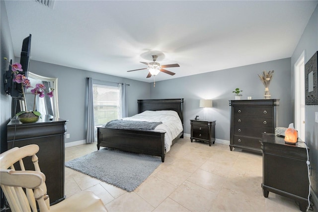 bedroom with ceiling fan and light tile patterned floors