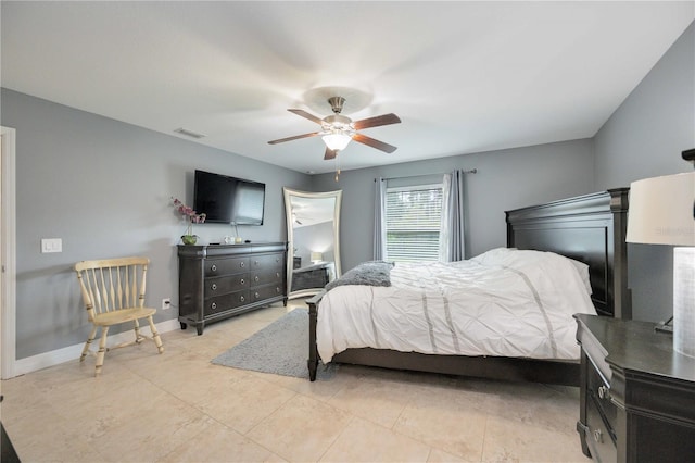 tiled bedroom featuring ceiling fan