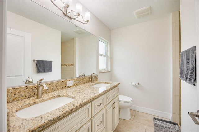 bathroom with tile patterned flooring, vanity, and toilet