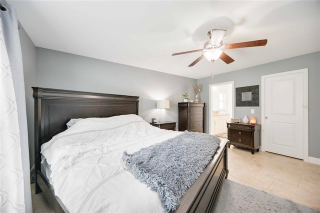 bedroom featuring ceiling fan, light tile patterned flooring, and connected bathroom