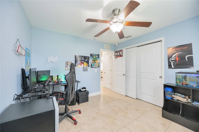 home office with light tile patterned floors and ceiling fan