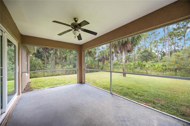 unfurnished sunroom with a wealth of natural light and ceiling fan