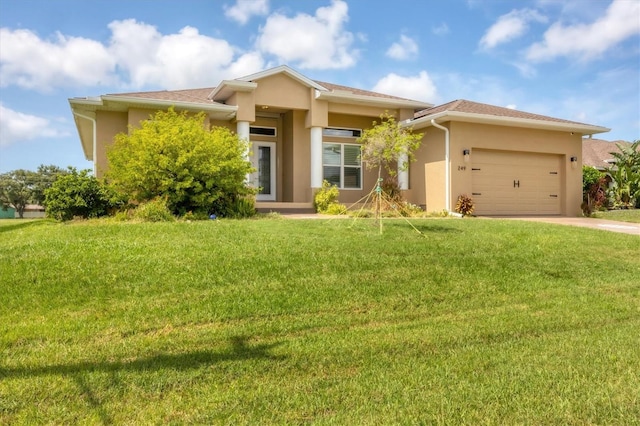 prairie-style home featuring a front lawn and a garage