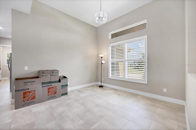 interior space featuring an inviting chandelier and light tile patterned flooring