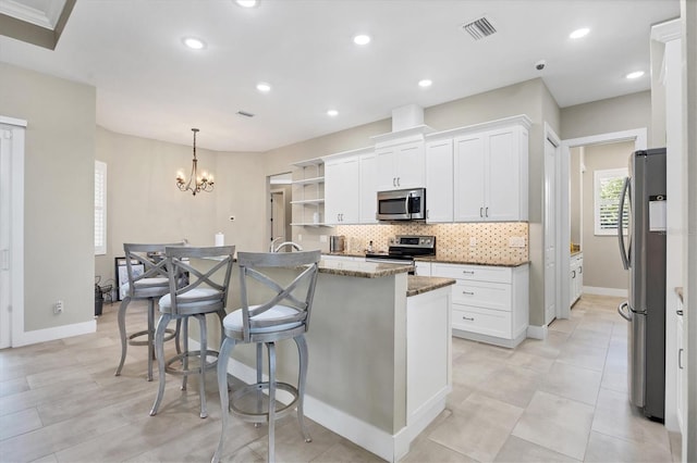 kitchen with white cabinets, an island with sink, and stainless steel appliances