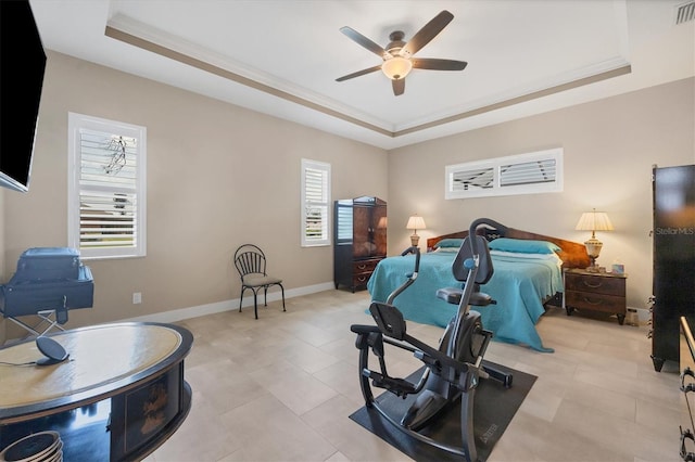 bedroom featuring crown molding, light tile patterned floors, a tray ceiling, and ceiling fan