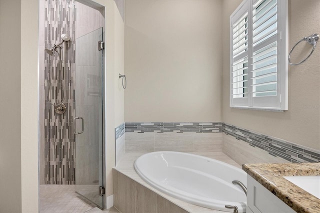 bathroom with shower with separate bathtub and vanity