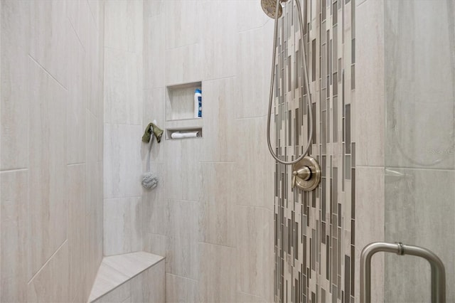 bathroom featuring a shower with door