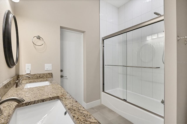 bathroom with bath / shower combo with glass door, vanity, and tile patterned floors