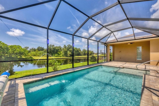 view of pool featuring a water view, a patio area, and glass enclosure