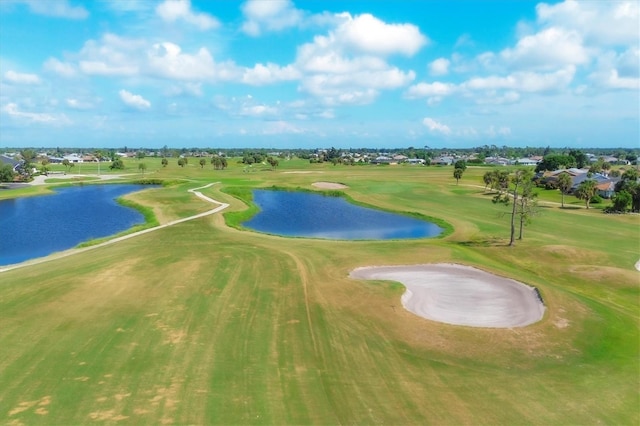 view of property's community featuring a yard and a water view