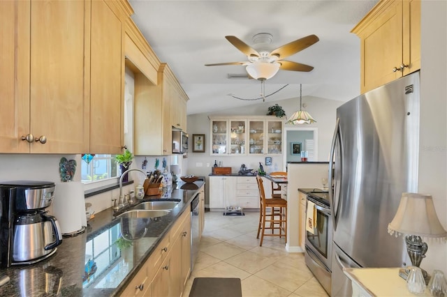 kitchen with ceiling fan, light brown cabinets, lofted ceiling, sink, and appliances with stainless steel finishes