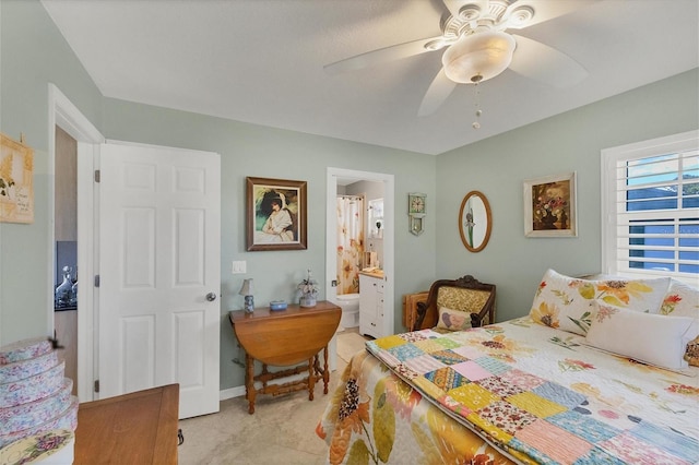 bedroom featuring ensuite bath and ceiling fan