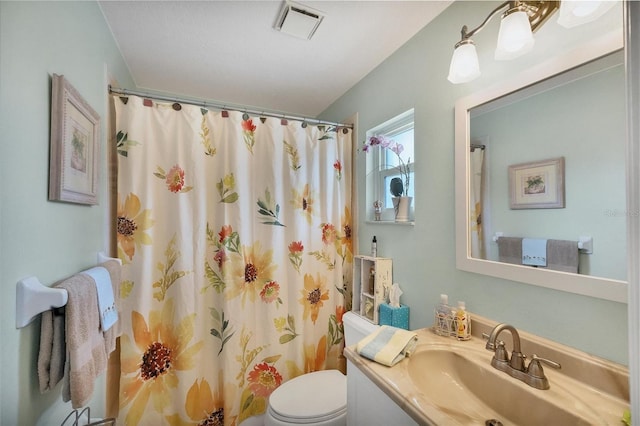 bathroom with vanity, toilet, and a shower with shower curtain