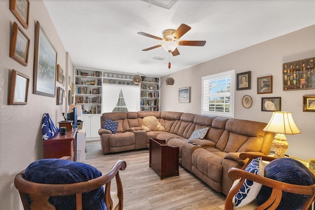 living room featuring ceiling fan and light wood-type flooring