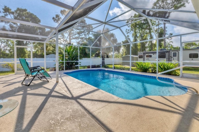 view of swimming pool with a lanai and a patio area