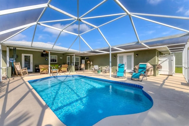 view of pool featuring a patio, a lanai, ceiling fan, and french doors