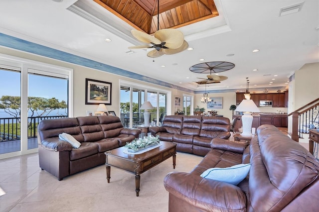 living room with wood ceiling, ceiling fan, a raised ceiling, and light tile patterned floors